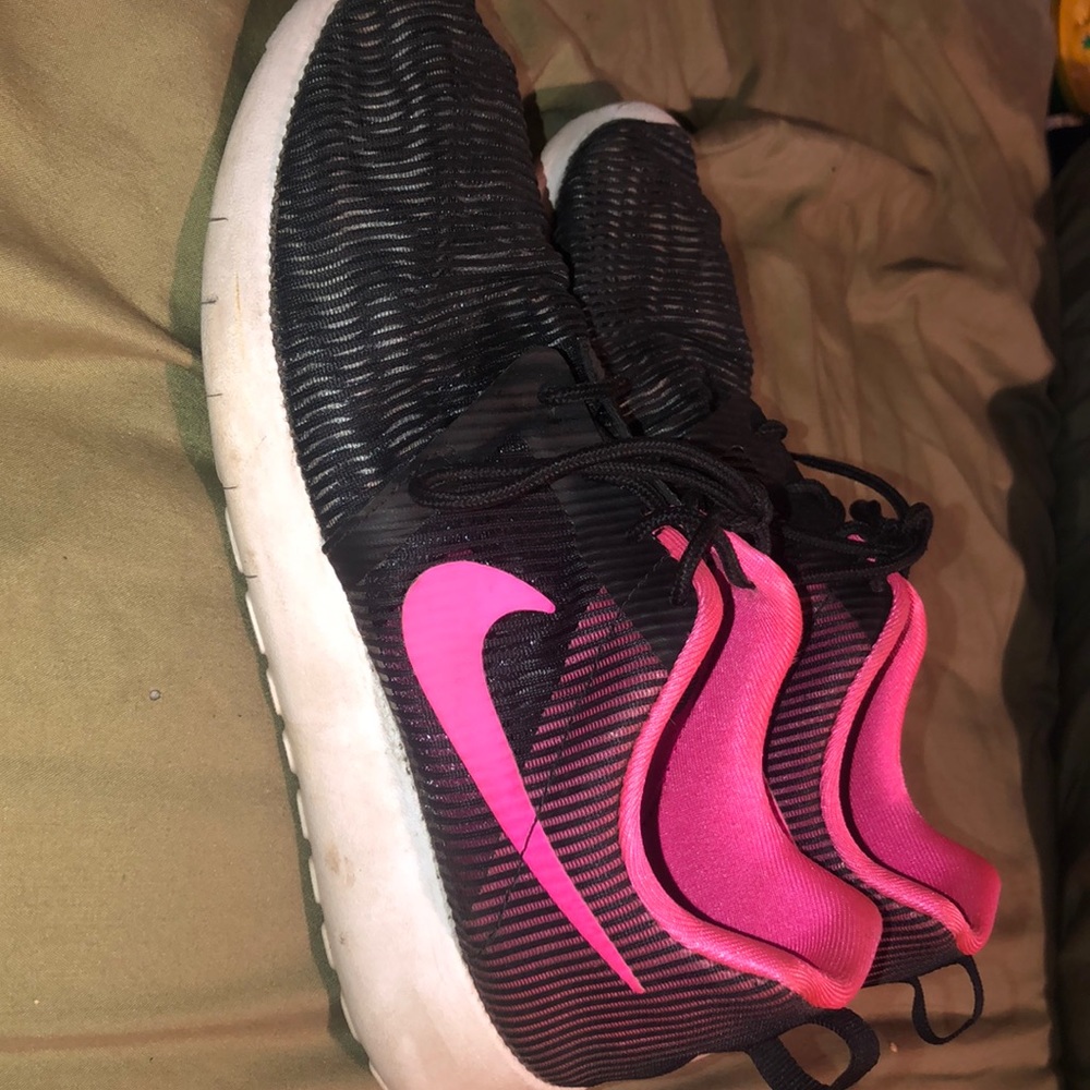 Pink and black nike running shoes